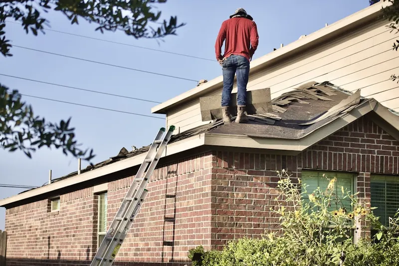 Professional roofer working on a residential roof in Laguna Beach